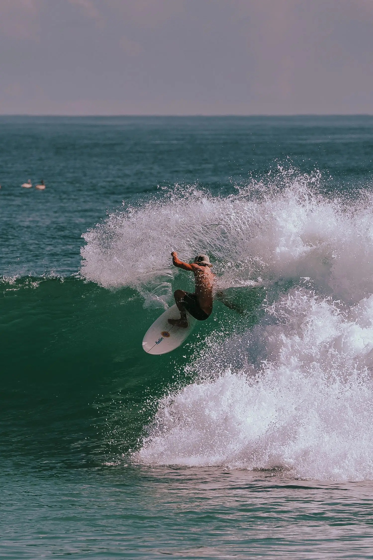 Surfer performing a powerful turn in a competition-style wave