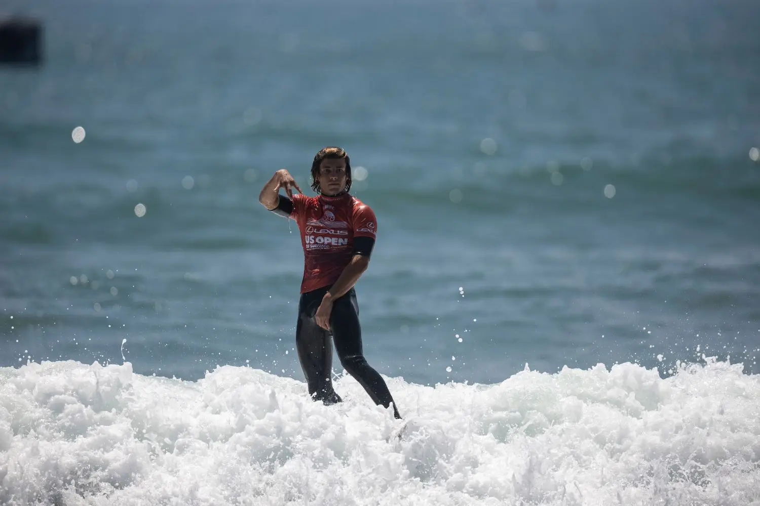 Surfer running from the shore with a board during an event
