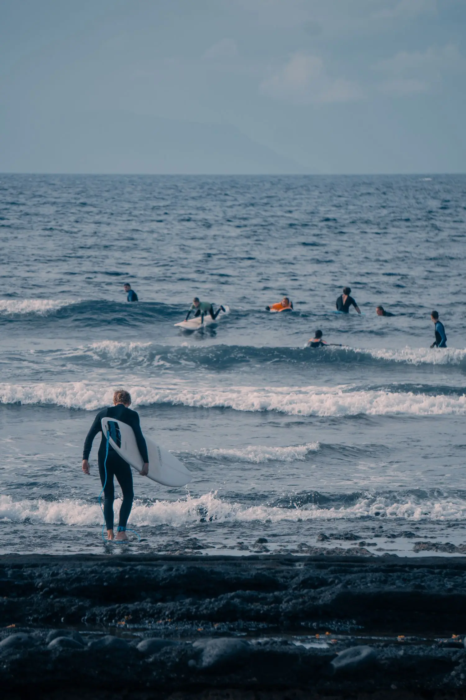 Group of surfers waiting beyond the shore break